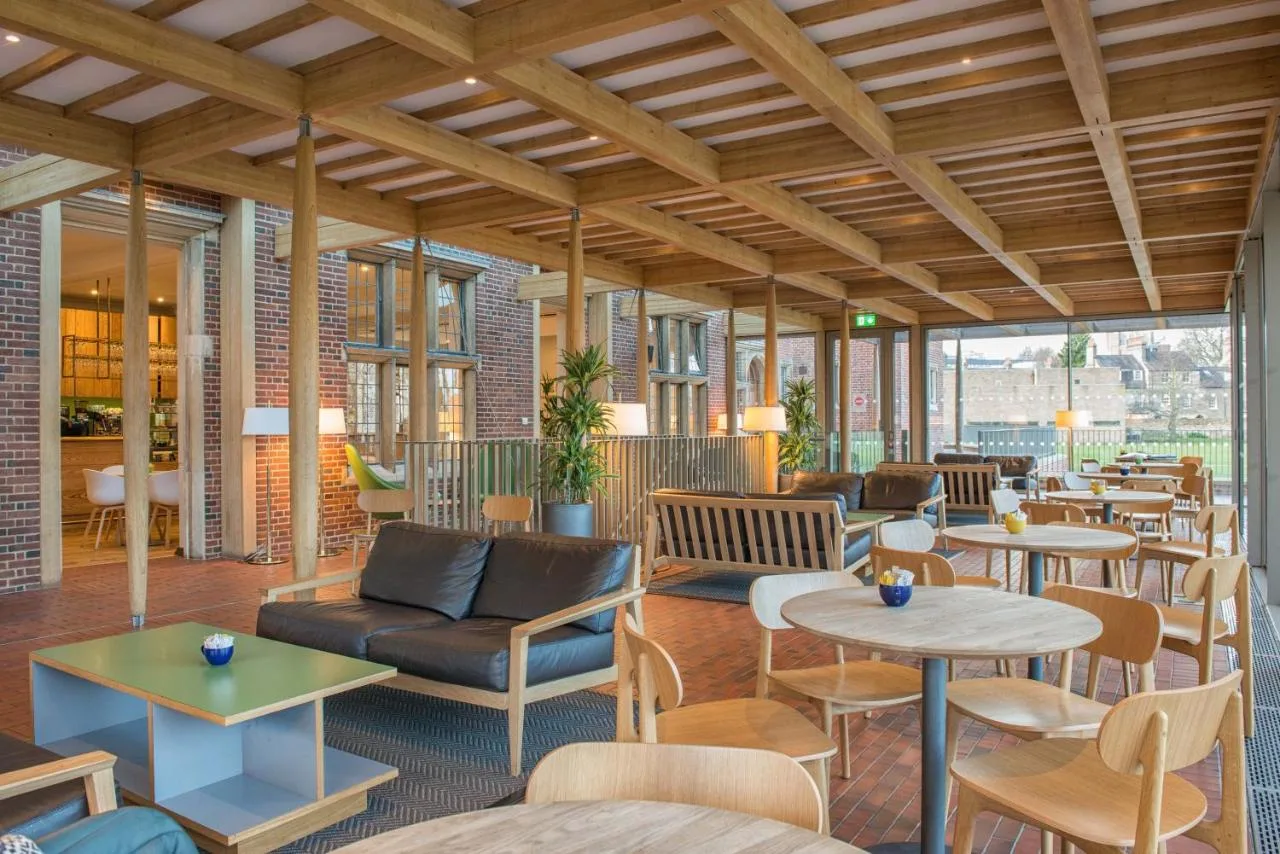 a lobby with tables and couches and chairs at West Court- Jesus College in Cambridge