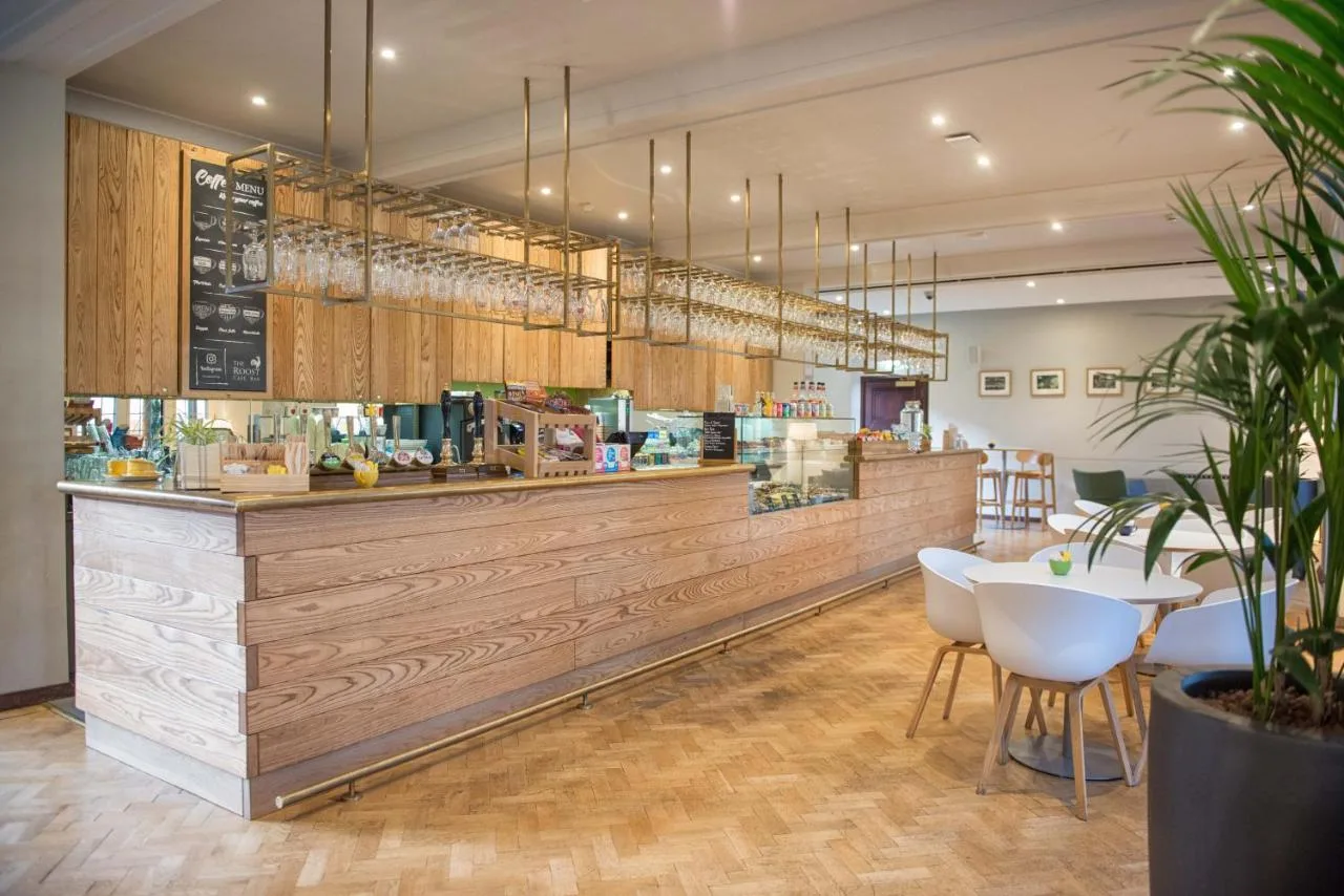 a restaurant with a counter with a table and chairs at West Court- Jesus College in Cambridge
